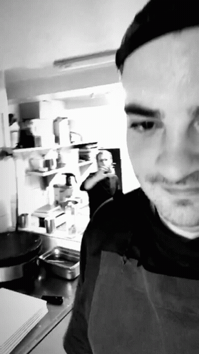Man In Apron Taking Selfie In Kitchen GIF