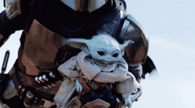 Man In Armor Carrying Baby Yoda GIF