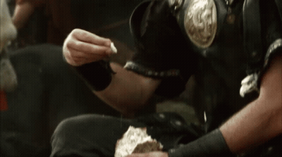 Man In Armor Eating Bread GIF