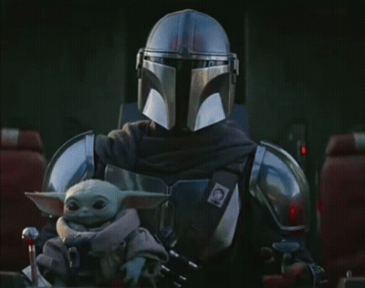 Man In Armor Holding Baby Yoda GIF