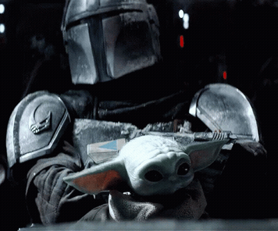 Man In Armor Holding Baby Yoda GIF