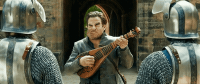 Man In Armor Playing Instrument In Front Of Knights GIF