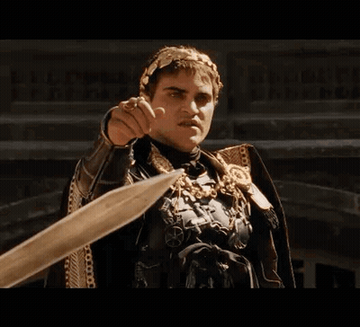 Man In Armor Pointing Sword At Camera GIF