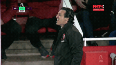 Man In Arsenal Jacket In Front Of Screen Saying Mat GIF