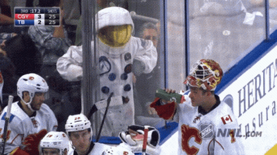 Man In Astronaut Costume Drinking Green Bottle GIF