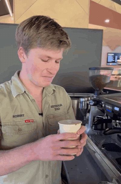 Man In Australia Zoo Shirt Holding Cup GIF