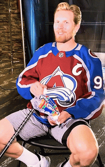 Man In Avalanche Jersey Holding Toothpaste GIF