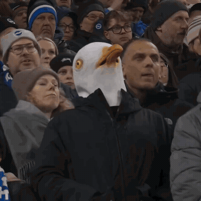 Man In Bald Eagle Mask In Crowd GIF