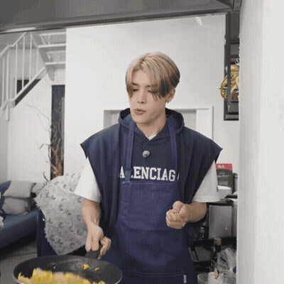 Man in Balenciaga Apron Cooking