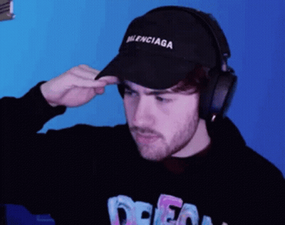 Man In Balenciaga Hat Adjusting Headphones GIF
