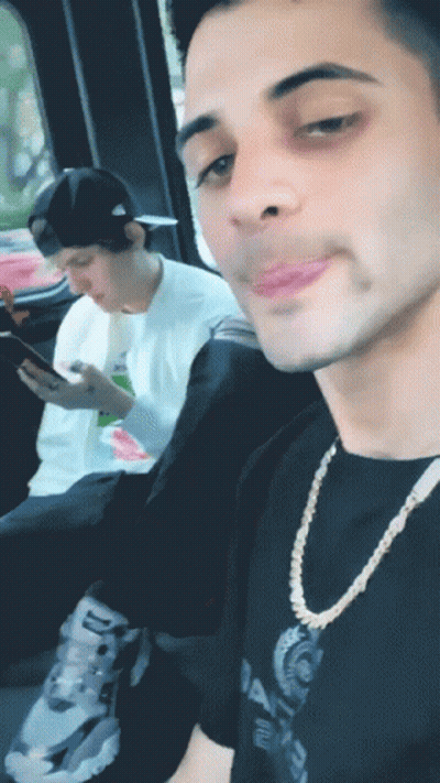 Man In Balenciaga Shirt Looking At Phone GIF
