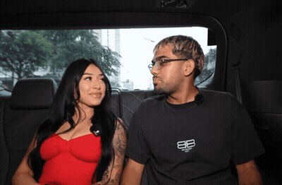 Man In Balenciaga Shirt Next To Woman In Red Top GIF