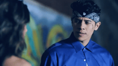 Man In Bandana And Blue Shirt Looking At Woman GIF