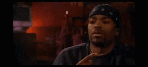 Man In Bandana And Hat Sitting At Candlelit Table GIF