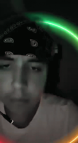 Man In Bandana And Headphones Looking At Camera GIF
