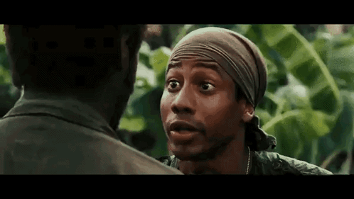Man In Bandana Talking To Another In Forest GIF