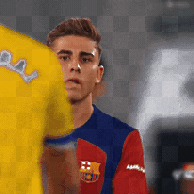 Man In Barcelona Jersey Next To Man In Yellow Shirt GIF