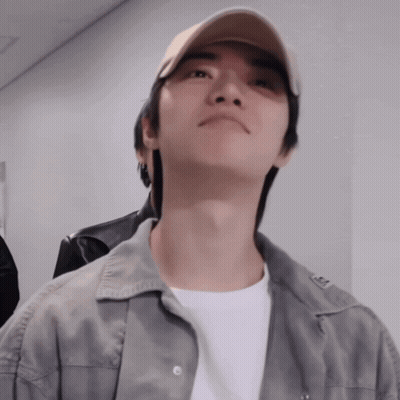 Man In Baseball Cap And Grey Jacket Looks Up GIF