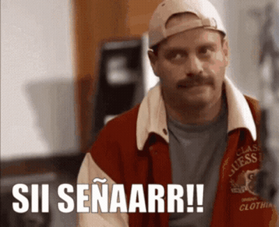 Man In Baseball Cap And Guess Jacket Says Sii Sen Arr GIF