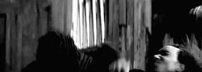Man In Baseball Cap And Jacket Standing Before Wall GIF