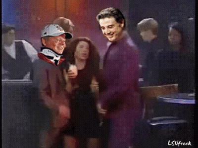 Man In Baseball Cap And Neck Brace Standing Next To Another Man GIF