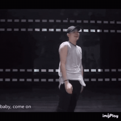 Man In Baseball Cap And Sunglasses In Front Of Wall Saying Baby Come On GIF