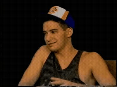 Man In Baseball Cap And Tank Top Pointing Up GIF