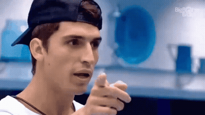 Man in Baseball Cap and White Shirt Pointing