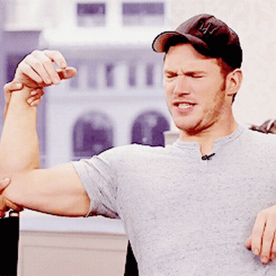 Man In Baseball Cap Flexing Muscles GIF