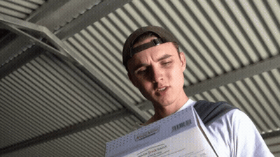 Man in Baseball Cap Holding Paper Saying Made Fresh Daily