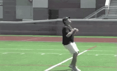Man In Baseball Cap Jumping On Field GIF
