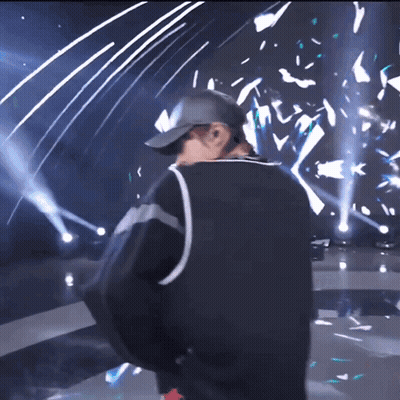 Man In Baseball Cap On Stage GIF
