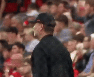 Man In Baseball Cap Standing Before Crowd GIF