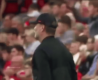 Man In Baseball Cap Standing Before Crowd GIF