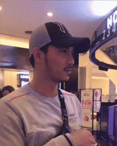 Man In Baseball Cap With N In Front Of No Smoking Sign GIF