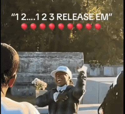 Man In Baseball Cap With Red Balloons Saying 123 Release Em GIF