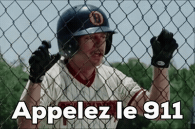 Man In Baseball Uniform Behind Fence Appelez Le 911 GIF