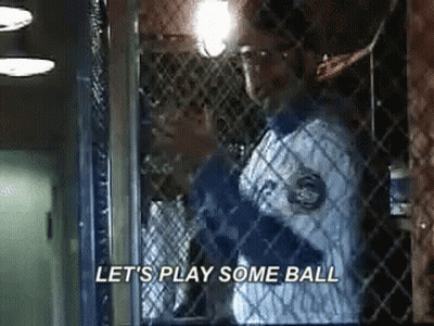 Man In Baseball Uniform Behind Fence Saying Let's Play Some Ball GIF