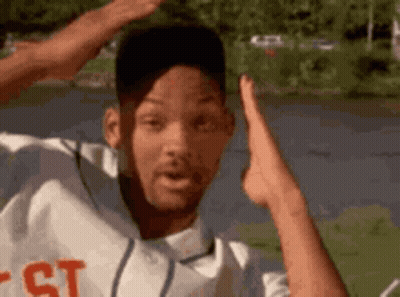 Man In Baseball Uniform Hands In Air At Lake GIF