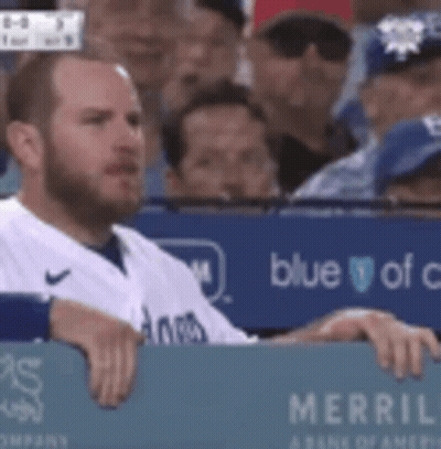 Man In Baseball Uniform Sitting In Dugout GIF