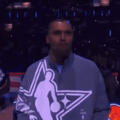 Man In Basketball Player Sweatshirt In Front Of Crowd GIF