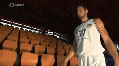 Man In Basketball Uniform In Empty Stadium GIF