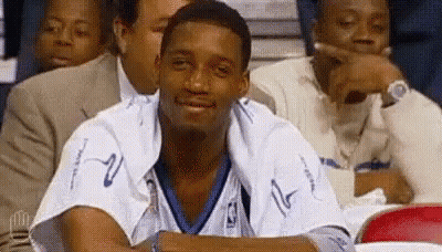 Man In Basketball Uniform Sitting In Stadium GIF
