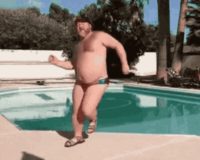 Man In Bathing Suit Running By Pool GIF