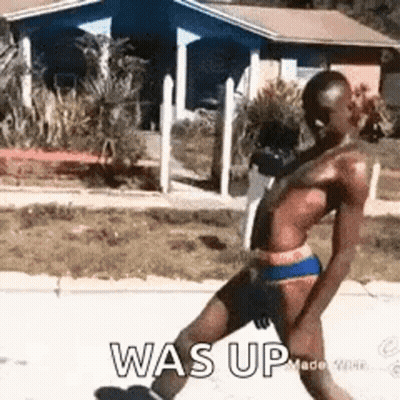Man In Bathing Suit Walking Down Street GIF