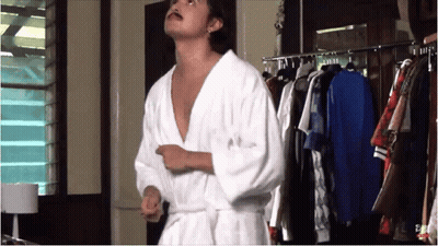 Man In Bathrobe In Front Of Closet GIF