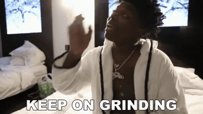 Man In Bathrobe Sitting On Bed Saying Keep On Grinding GIF