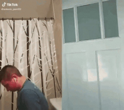 Man In Bathroom Next To Door And Shower Curtain GIF