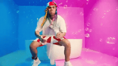 Man In Bathtub With Bubbles In Colorful Room GIF