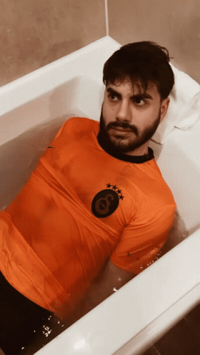 Man In Bathtub With Orange Shirt Letter G GIF